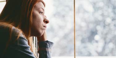 Woman looking out of window