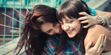 Two sister embracing being playful