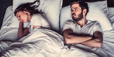 wife rolled away from angry husband in bed