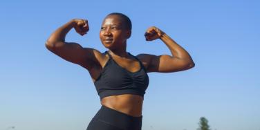 muscular woman posing with arms up