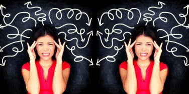 woman wincing with squiggled lines on chalkboard behind her