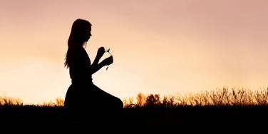 woman meditating in sunset