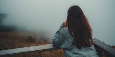 woman looking out at fog