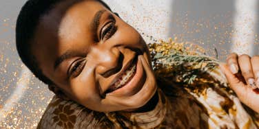 Woman smiling holding flowers