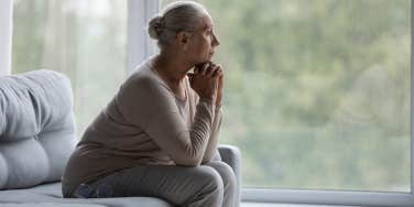 older woman looking out the window