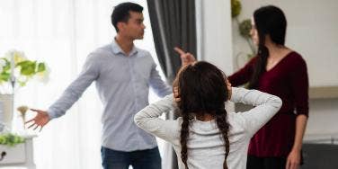 girl listening to parents arguing