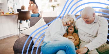 Grandparents playing with their granddaughter while mother focuses