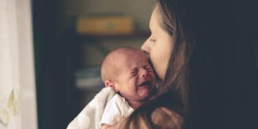 woman holding crying baby