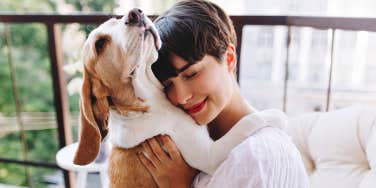 woman hugging dog