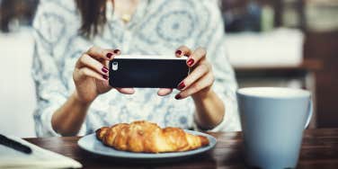 woman taking photo of food