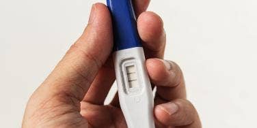 hand holding pregnancy test