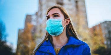 woman wearing a mask outside in city