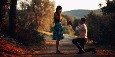 woman being proposed to in woods