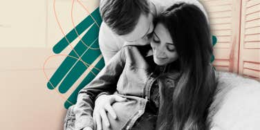 a pregnant woman and a man embrace and smile