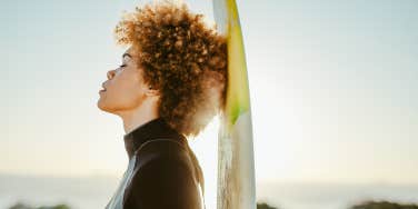 surfer woman breathing with closed eyes