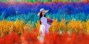 woman standing in front of a rainbow