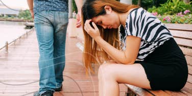 woman sitting on bench sad