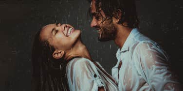 Couple laughing in the rain together