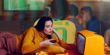 woman watching tv and man watching sports