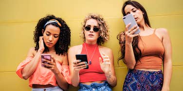 Three women checking their phones frustrated men haven't called back