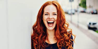 red-haired woman laughing 