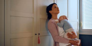 distraught woman holding her baby