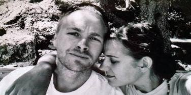 Woman putting her head on shoulder of man sitting next to her