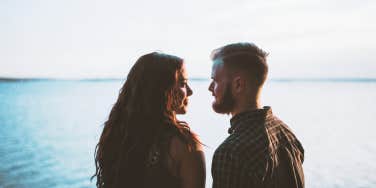 Two people talking by water 