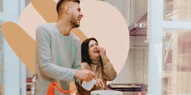 Couple in kitchen together laughing