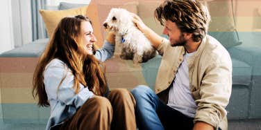 Couple chatting while petting their dog 