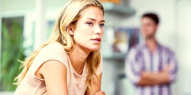 Pensive woman thinking with partner in background