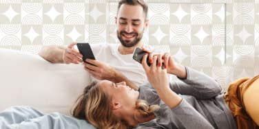 Couple on the couch laughing on their phones