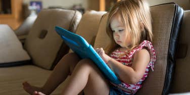 little girl using tablet