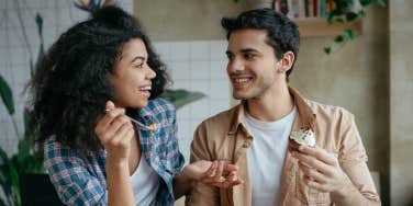 woman and man facing each other with inquisitive facial expressions