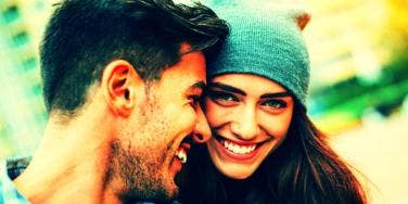 man and woman smiling and pressing cheeks together