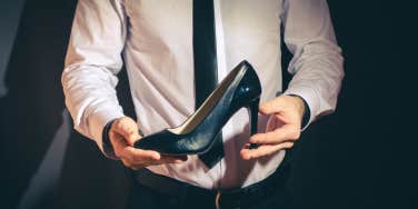 businessman holding a high heel