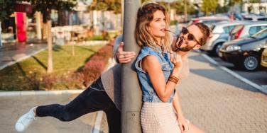 man and woman laughing and joking on the street