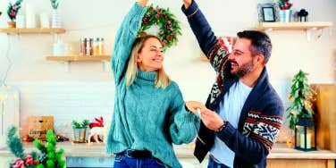 couple dancing in the kitchen to romantic Christmas songs