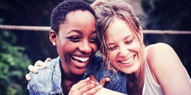 two women joyfully hugging