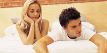 sad couple bed