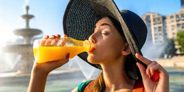 woman drinking orange juice