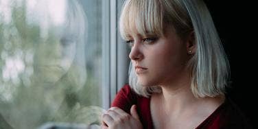 woman looking out window