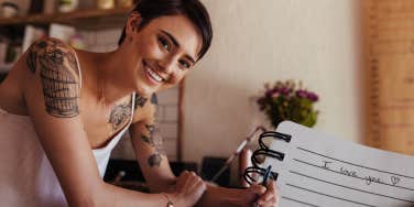 woman writing love note to show appreciation