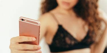 woman taking selfie with phone