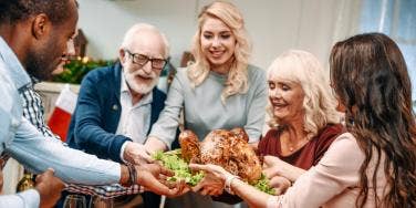 family holding a turkey together