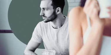 Man spacing out behind woman drinking coffee