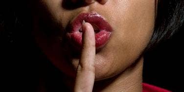 woman saying shhh