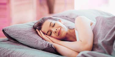 woman smiling in bed sleeping