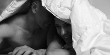 man and woman under covers