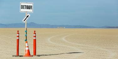 detour sign in the sand
